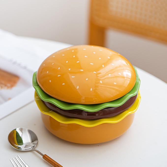 The Ceramic Hamburger Plates Collection is a creative 5-piece set of hamburger-shaped plates and bowls made of durable and elegant ceramic for a unique dining experience and fun.